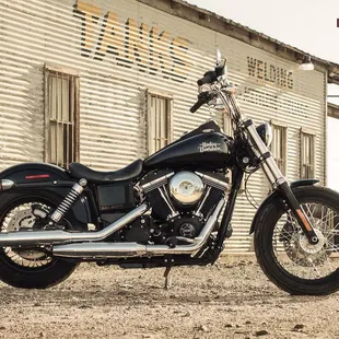 a black motorcycle parked in front of a building