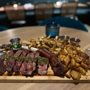 tomahawk with crispy potatoes and truffle fries