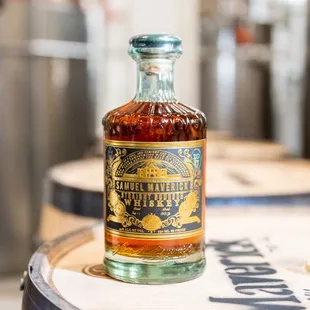 a bottle of bourbon on a barrel