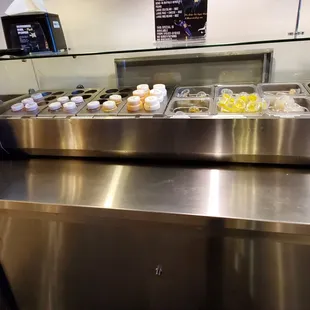 All of these little containers hold free condiments.