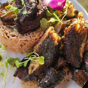 Pork jerk with rice &amp; peas base.  Everything is edible, even the flower.  Delicious!