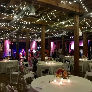 Stage for a live band in the front, dance floor and guest tables