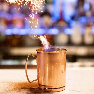 a copper mug with a sparkler coming out of it