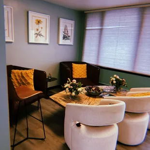 a living room with chairs and a table