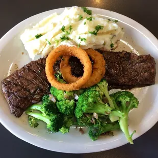Romanian skirt steak with mashed potatoes, broccoli, and onion rings
