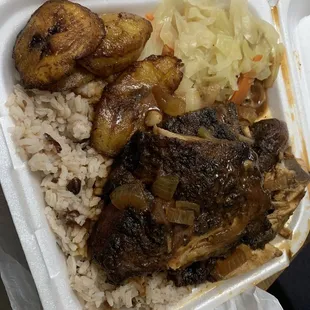 Jerk chicken platter. Small. (Still a large portion) rice and peas. Sweet plantains and steamed cabbage