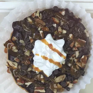 a chocolate dessert with whipped cream and nuts