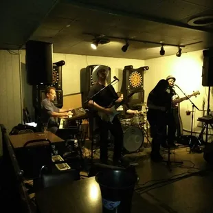a band playing in a dimly lit room