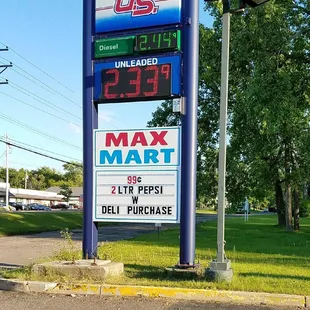 a gas station with a large sign