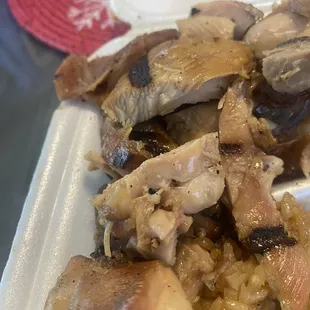 a plate of food with meat and rice