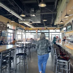 a woman walking through a bar