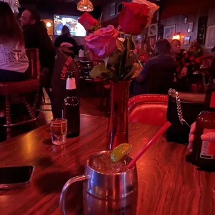 a vase of roses with a lime in it