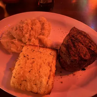 Filet mignon dinner with garlic, mashed potatoes and garlic bread