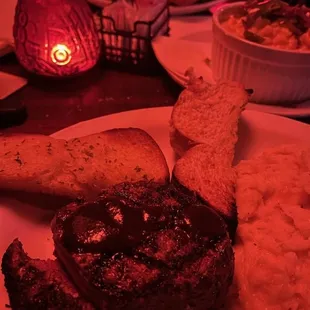 Filet Mignon, mashed tatoes, garlic bread, mac n cheese with jalapeno and bacon to the right. Bomb!