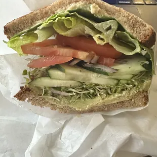 Hummus veggie sandwich with added avocado on multigrain bread! A light and yummy work lunch!!