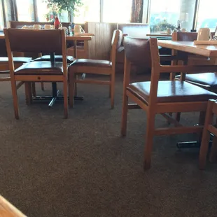 Dining area feels open with windowed walls that lets in natural light.