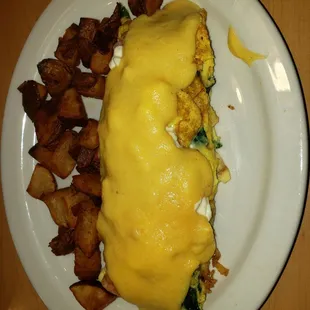 Crab, shrimp, spinach, &amp; feta omelet (semi-custom) topped with hollandaise sauce with oven-roasted potatoes.  So yummy!!!