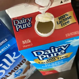 dairy pure milk being poured into a carton