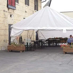 people sitting under a tent