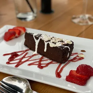 Gâteau au Chocolat- Flour-less chocolate cake, roasted hazelnuts, coconut sweetened crème fraîche.