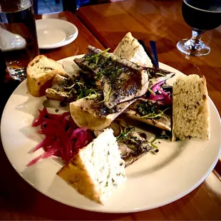 Canoe-cut Beef Bone Marrow with capers, pickled red onions, parsley and crostini - a lovely spread served on Focaccia bread - Try it!!!