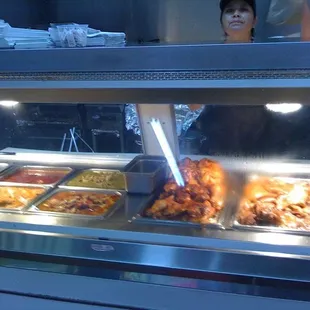 a woman behind a buffet