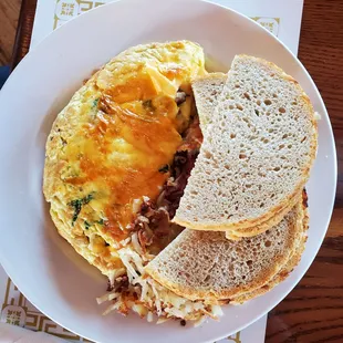 Mushroom omelette with crispy hash browns and sour dough