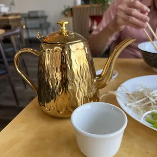 a woman eating a bowl of noodles