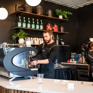 a bari serving a cup of coffee