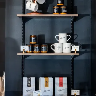 a shelf of coffee cups and mugs