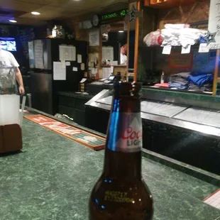a bottle of beer on a bar counter