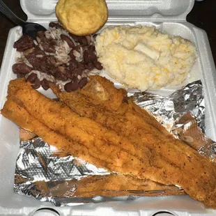 Fried Haddock plate with cheesy grits, Red Beans and Rice and a cornbread muffin.