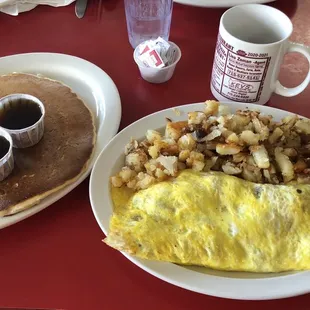 Meat lovers omelette with hash browns and pancake (as big as it looks).