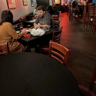two people sitting at a table in a restaurant