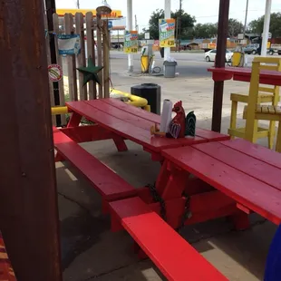 a red picnic table in a gas station