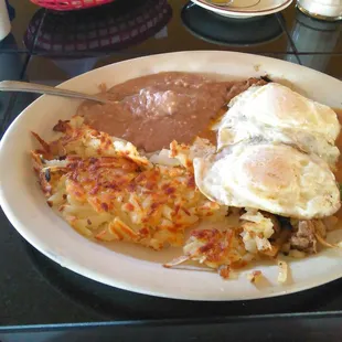 The House Specialty -- two eggs, any style with sirloin strips, onion, green pepper, and green chili with hashbrowns and refried beans