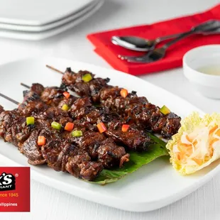 a plate of meat skewers