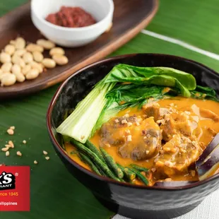 a bowl of soup with meat and vegetables