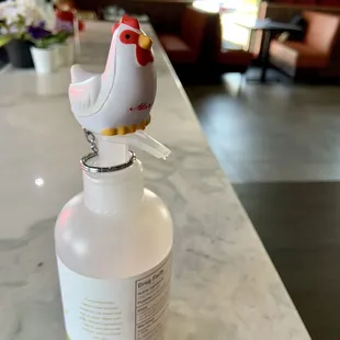 Inside: cute chicken sitting atop the hand sanitizer