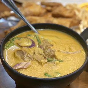 a bowl of soup with a spoon in it