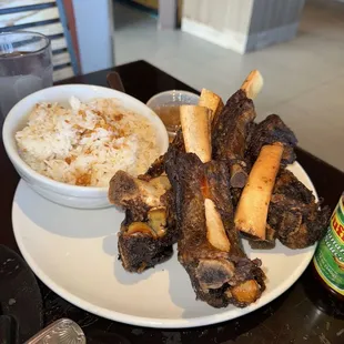 a plate of ribs and rice