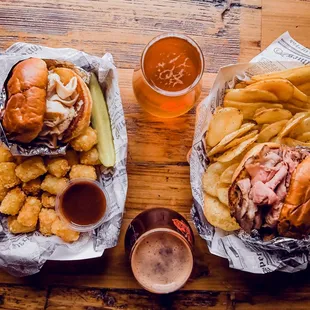 two trays of food and a glass of beer