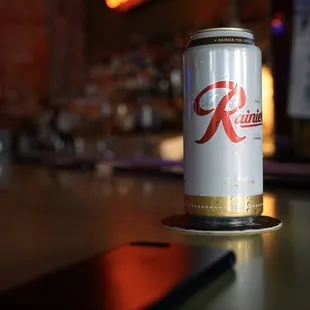 Enjoying a Rainier tall boy at the bar.