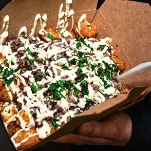 a person holding a box of food