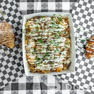 a tray of fries and a tray of macaroni and cheese