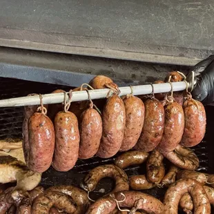 sausages being cooked on a grill