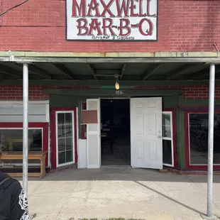 a woman standing in front of the restaurant