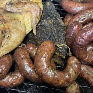 chicken and sausages on a grill