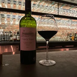 a bottle of wine and a glass of wine