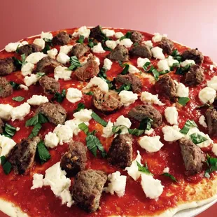 a pizza topped with meatballs and cheese